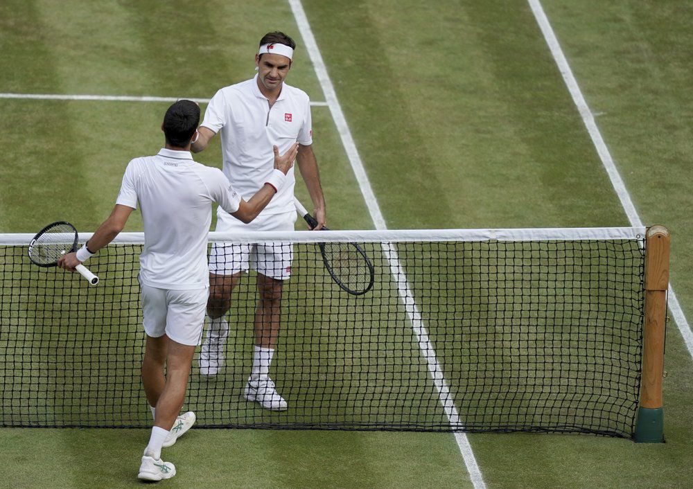 Novak Djokovic, left, shakes hands with Switzerland's Roger Federer